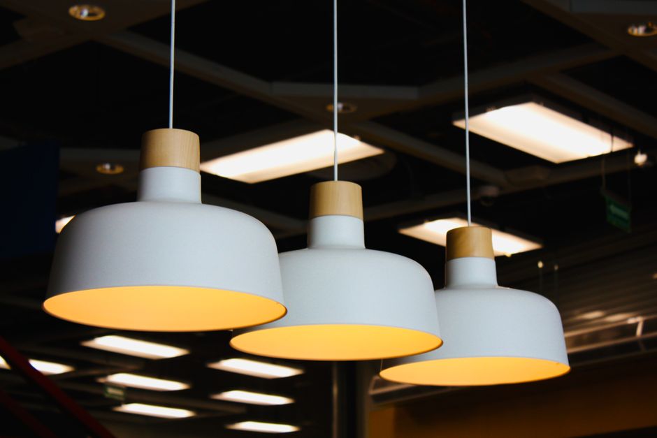Stylish pendant lights hanging in a modern indoor setting at night, creating a warm ambiance.
